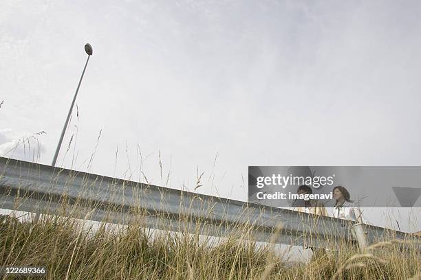 young couple and field - earth week stock pictures, royalty-free photos & images