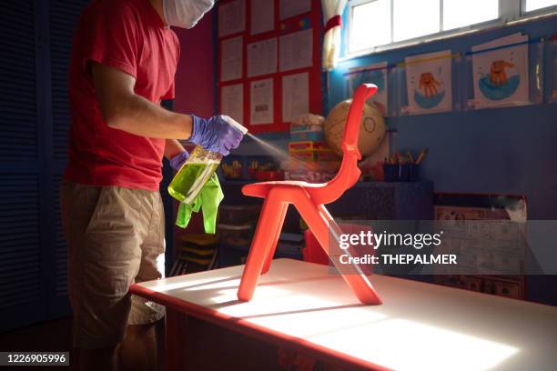 spraying over kids furniture with cleaning solution - disinfection school stock pictures, royalty-free photos & images