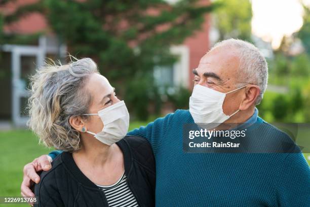 couple wear surgical masks - protective face mask happy stock pictures, royalty-free photos & images