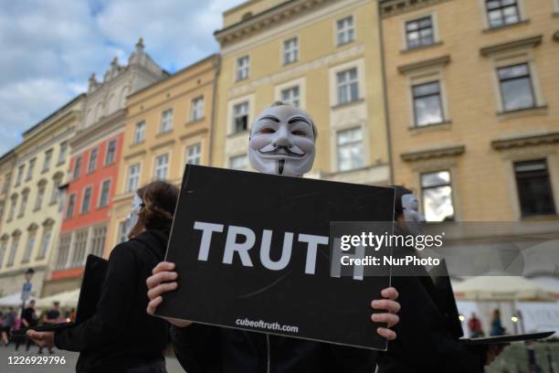 Activists from 'Anonymous for the Voiceless' wearing Guy Fawkes masks at a protest for veganism, in Krakow's Main Market Square. Activists held the...