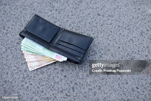 last wallet with euros on the street - wallet stockfoto's en -beelden