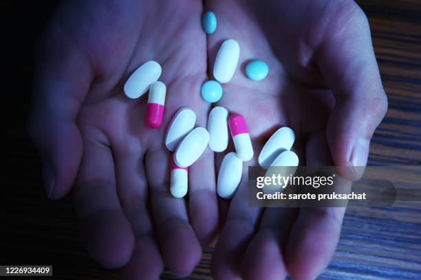 top view of the pills on the hand . - drug rehab stock pictures, royalty-free photos & images