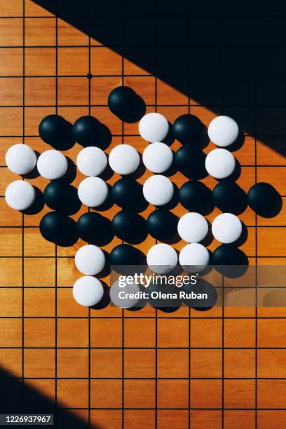 close-up wooden board for playing go with stones - go board game stock pictures, royalty-free photos & images