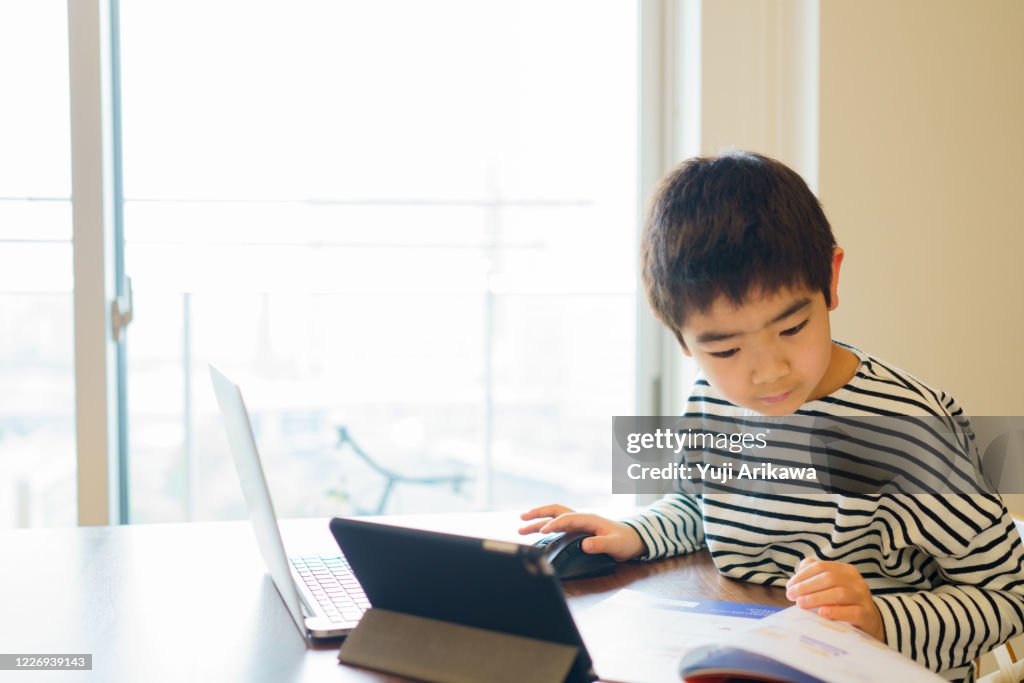 Boy learning online with computer