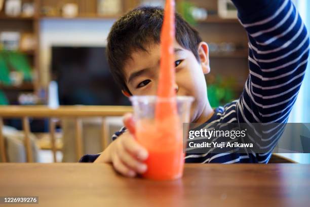 a boy doing an experiment at home - slime stock pictures, royalty-free photos & images