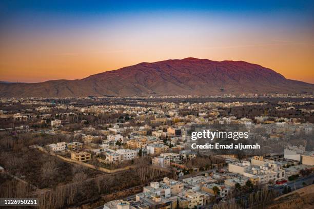 view of shiraz city surrounding hills, iran - shiraz stock-fotos und bilder