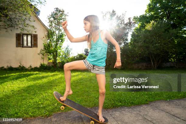 little girl riding on her skateboard - little ballet stock-fotos und bilder