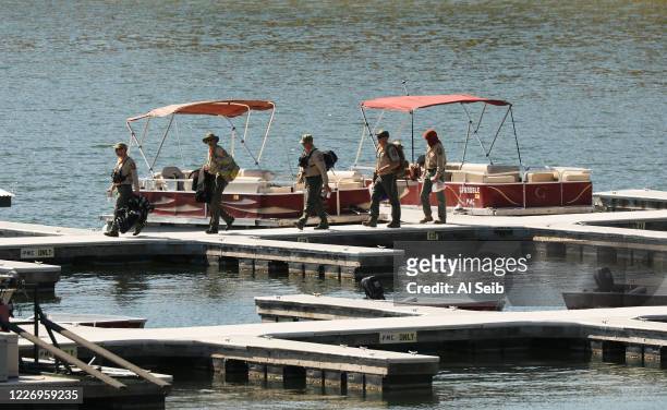 Ventura County Sheriffs Search and Rescue dive team return to the marina after they located a body Monday morning in Lake Piru as the search...
