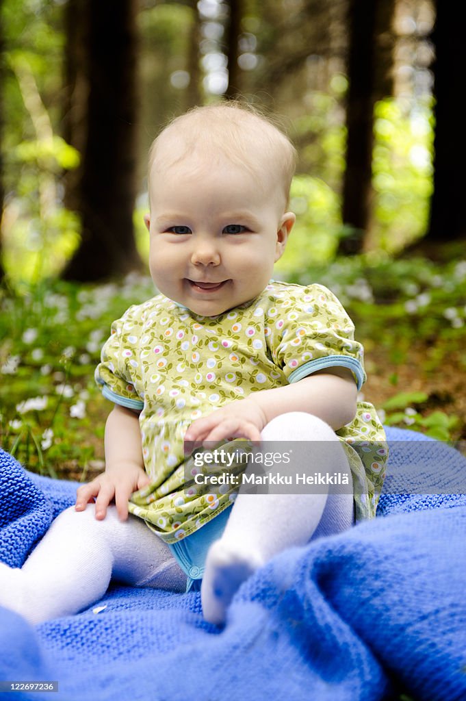 Baby sitting in forest