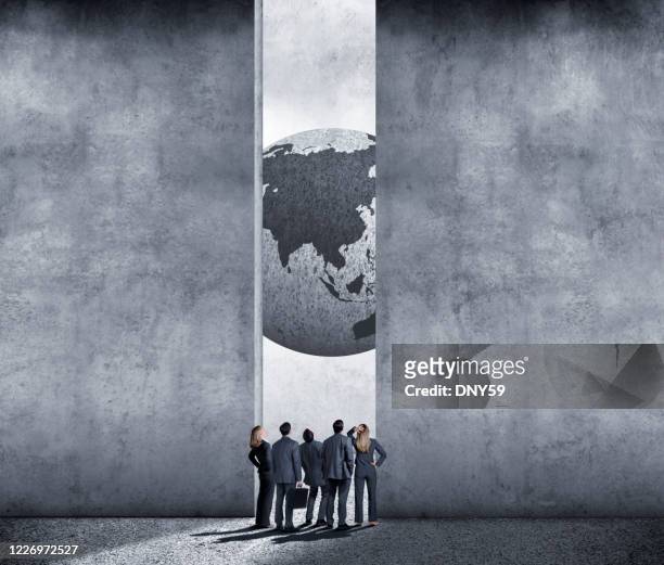 business people looking up at globe showing asia - capitalism stock pictures, royalty-free photos & images