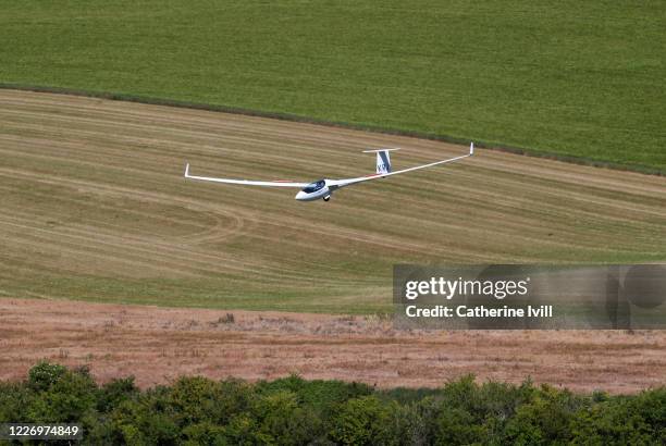 Glider from the London Gliding clubs glides over the Chiltern Hills on May 25, 2020 in Dunstable Downs, England. The British government has started...