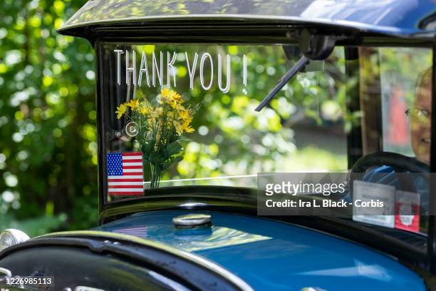 On Memorial Day a historic car that has Thank You! with an American Flag takes part in the vehicular motorcade parade and ceremony to show support...