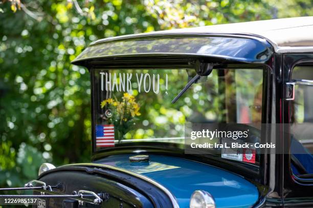 On Memorial Day a historic car that has Thank You! with an American Flag takes part in the vehicular motorcade parade and ceremony to show support...