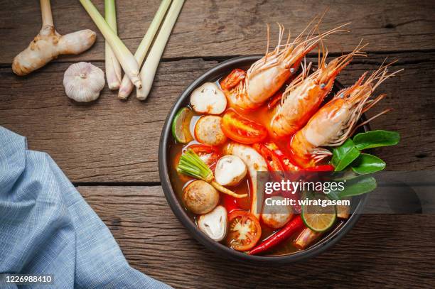 tom yum kung is thai food hot spicy soup with shrimp, lemon grass, lemon, straw mushroom and chilli. - straw mushroom stock pictures, royalty-free photos & images