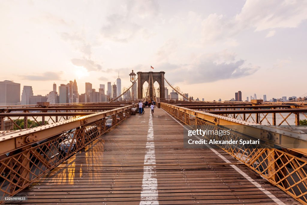Brooklyn Bridge and Manhattan skyline at sunset, New York City, USA