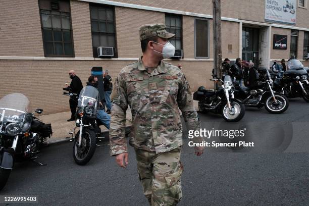 Member of the U.S. Air Force wears a face mask while participating in the annual Memorial Day Parade on May 25, 2020 in the Staten Island borough of...
