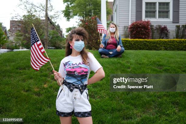 People wear face masks while participating in the annual Memorial Day Parade on May 25, 2020 in the Staten Island borough of New York City. Dozens of...