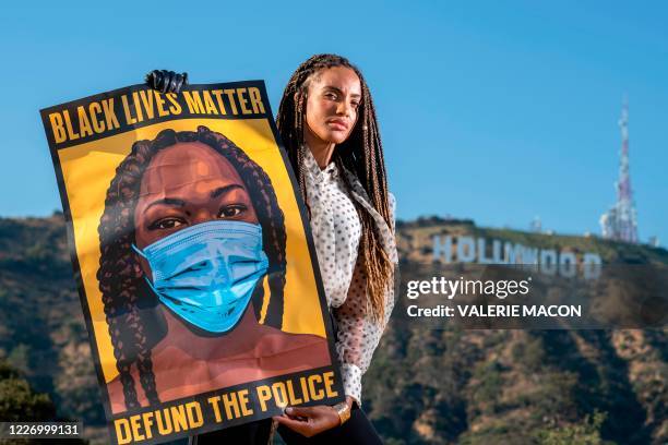 Ciera Foster, actress and co-founder of Blac 4 Black Lives, poses in front of the Hollywood sign, June 28 in Los Angeles, California. - In a town...