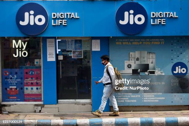 Man walks past Jio store in Kolkata, India, 13 July, 2020. On Sunday, India's Reliance Industries stated that Qualcomm Inc will buy a 0.15% stake in...