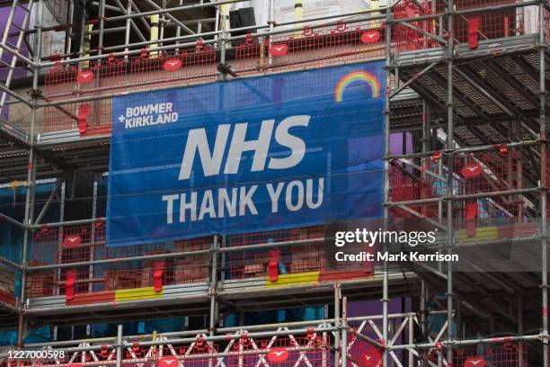 Sign reading NHS Thank You is displayed on scaffolding around a construction site on 1st July 2020 in Windsor, United Kingdom. People around the UK...