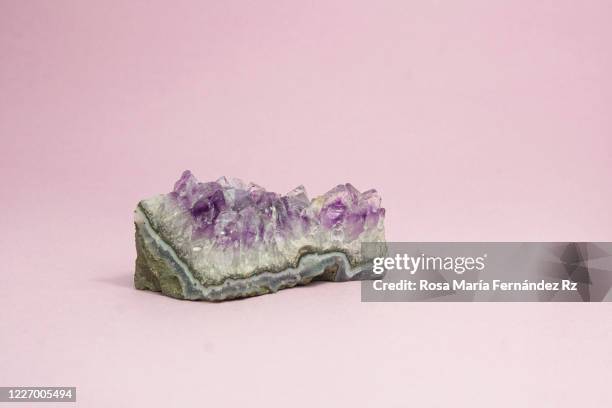 specimen of purple amethyst crystal geode over pastel pink background. copy space - calcite stock pictures, royalty-free photos & images