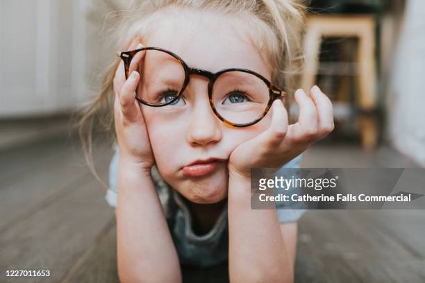 bored child in glasses - bores stock pictures, royalty-free photos & images
