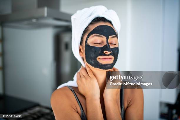 smiling woman having a spa day at home. - pores closeup stock pictures, royalty-free photos & images