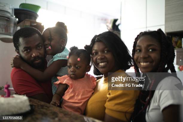portrait of a happiness family celebrating a birthday party at home - black family reunion stock pictures, royalty-free photos & images