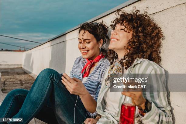 enjoying a summer afternoon on the roof - afternoon stock pictures, royalty-free photos & images