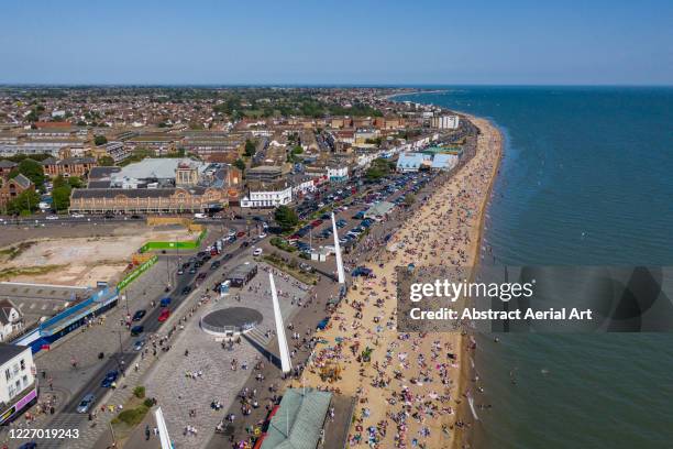 sunbathers on a beach during covid-19 pandemic, southend-on-sea, essex, united kingdom - southend on sea stock pictures, royalty-free photos & images