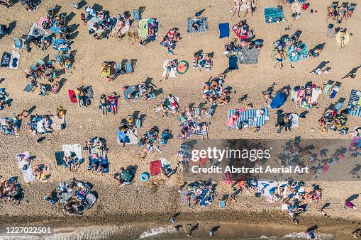 Sunbathers relaxing on Southend Beach as seen from directly above, Southend-on-Sea, Essex, United Kingdom Sunbathers relaxing on Southend Beach as seen from directly above, Southend-on-Sea, Essex, United Kingdom