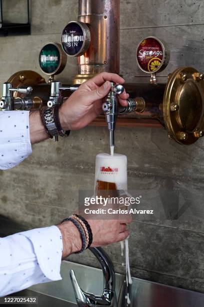 Sabino Casado taps a beer in his restaurant Terraceria on May 25, 2020 in Madrid, Spain. Some parts of Spain have entered the so-called "Phase One"...
