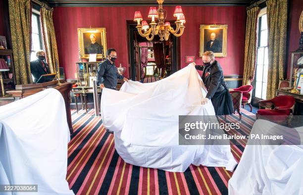 Head housekeeper Amit Pal and general manager Alan McGuiggan remove dust sheets from the furniture as they make last minute preparations at...