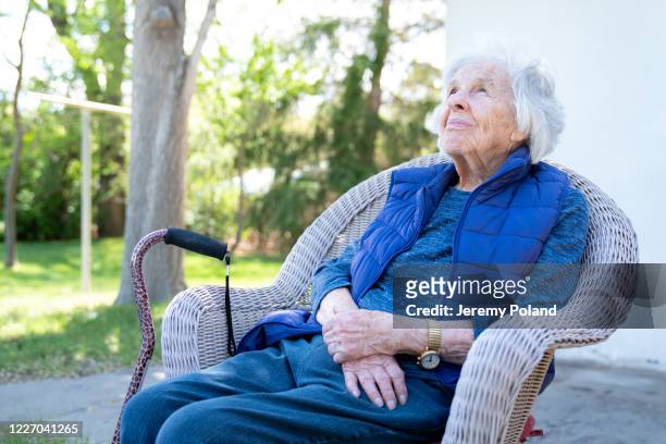 beautiful 90 plus year-old elderly senior caucasian woman sitting outdoors in the summer - one senior woman only stock pictures, royalty-free photos & images