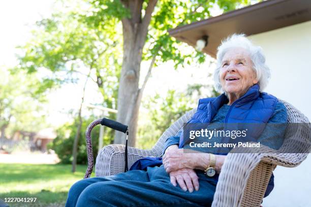 beautiful 90 plus year-old elderly senior caucasian woman sitting outdoors in the summer - retirement community staff stock pictures, royalty-free photos & images