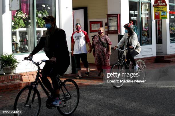 Pedestrians walk down Commercial Street on May 25, 2020 in Provincetown, Massachusetts. Massachusetts has begun Phase 1 of reopening after the...