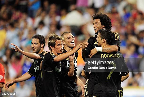 Cristiano Ronaldo of Real Madrid celebrates with Marcelo and Fabio Coentrao after scoring his third goal during the La Liga match between Real...