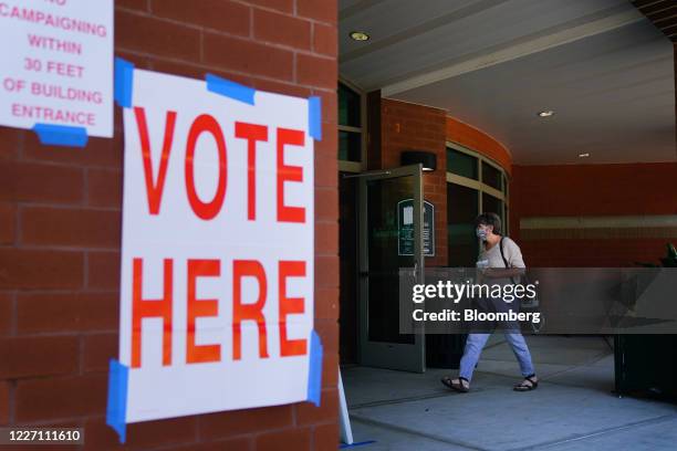 Voter wearing a protective mask enters a polling location in Opelika, Alabama, U.S., on Tuesday, July 14, 2020. Jeff Sessions' bid to reclaim an...