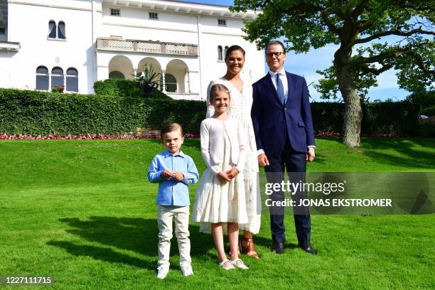 Crown Princess Victoria Prince Daniel and their two children Oscar and Estelle pose in the garden of the family summer palace Solliden on Oland...