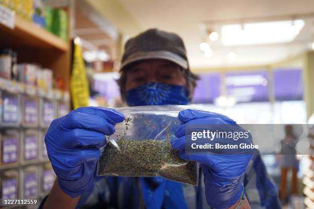 Employee Charles Pitetti, fills bags of herbs and spices, an incredibly labor intensive job, according to Debra Stark, the store's owner, on June 24,...