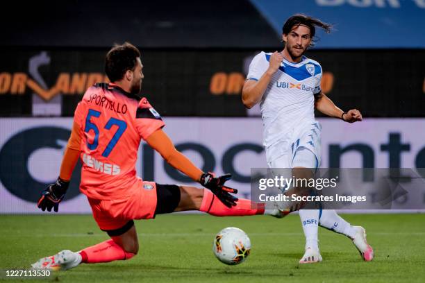 Ernesto Torregrossa of Brescia scores the second goal to make it 1-1, Marco Sportiello of Atalanta Bergamo during the Italian Serie A match between...