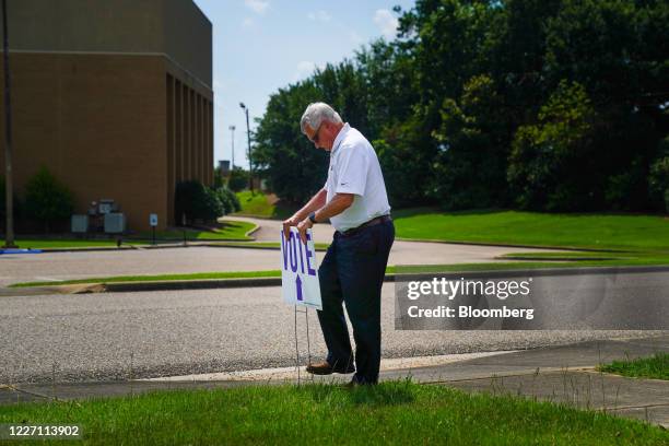 Person sets up a "Vote" sign outside a polling location in Montgomery, Alabama, U.S., on Tuesday, July 14, 2020. Jeff Sessions' bid to reclaim an...