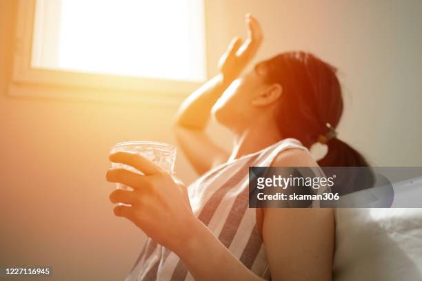 asian female thirsty and dehydration drinking fresh water at summer season at home - heat temperature 個照片及圖片檔