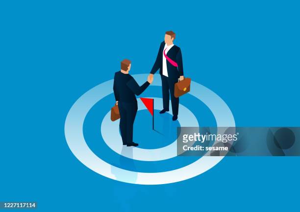 common goal, reach agreement, two businessmen stand on the bullseye and shake hands - diplomacy stock illustrations