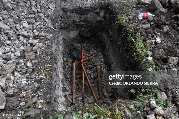 View of shovels, bars and pickaxes used to dig graves for victims of COVID-19 in an annex of the Parque Memorial Jardin de los Angeles cemetery,14...