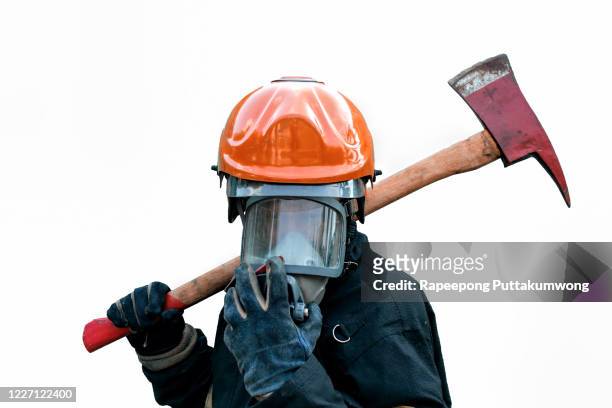 firefighter holding axe. fire prevention and extinguishing concept. - fireman axe stock pictures, royalty-free photos & images