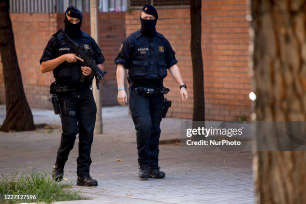 Members of the Catalan regional police force Mossos d'Esquadra stand guard during an counter-terrorism operation in Barcelona, on July 14, 2020. The...