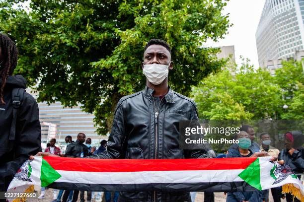 Sudanese man is holding a Sudanese flag, during the demonstration against the deportations back to Sudan, in The Hague, Netherlands on July 14th,...