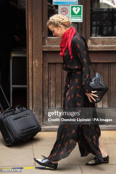 Actress Amber Heard looks down at a social distancing marker on the floor as she arrives at the High Court in London for a hearing in Johnny Depp's...