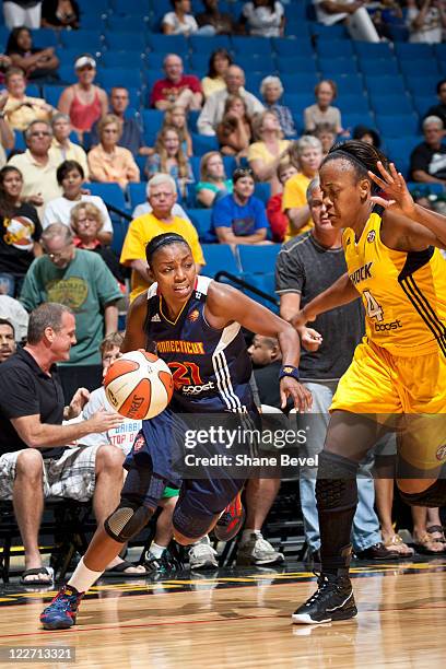 Renee Montgomery of the Connecticut Sun drives past Amber Holt of the Tulsa Shock during the WNBA game on August 28, 2011 at the BOK Center in Tulsa,...